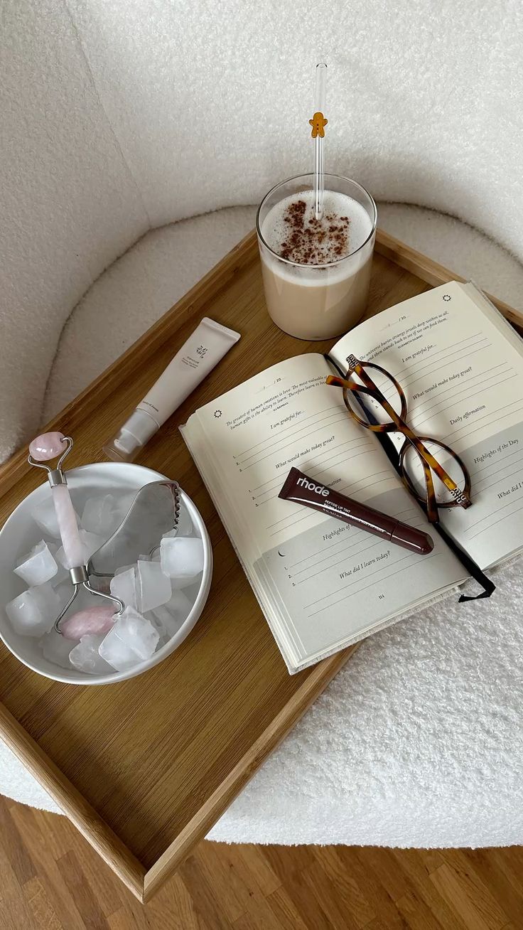 Minimal morning routine setup with water, breakfast, and a wellness journal.
